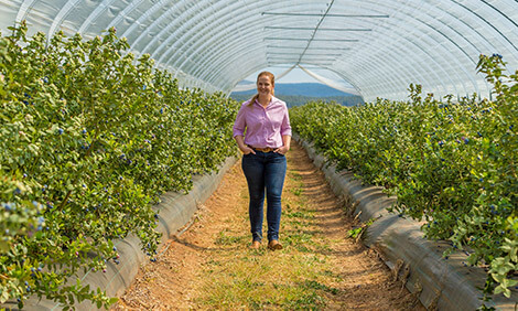 Natalie Lismore walking in a greenhouse in Lismore, New South Wales