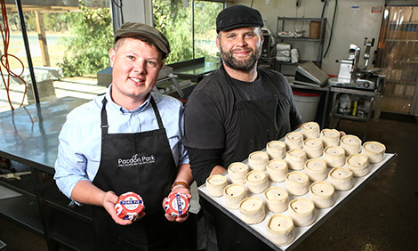 Two bakers from Pacdon Park in Echuca Victoria holding a tray of pork pies in a bakery