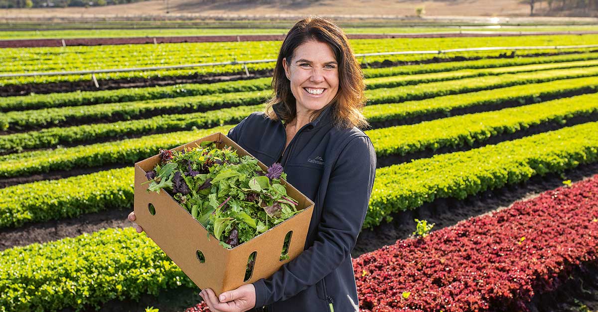 Belinda Adams holding a box of greens