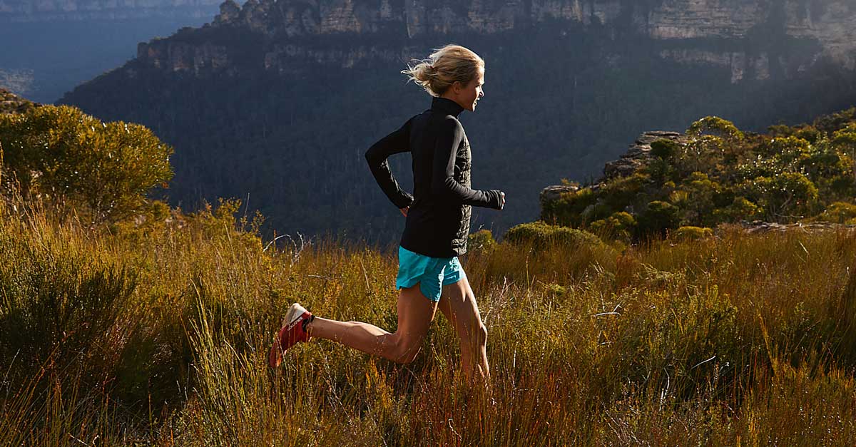 Lucy Bartholomew running through mountain trail