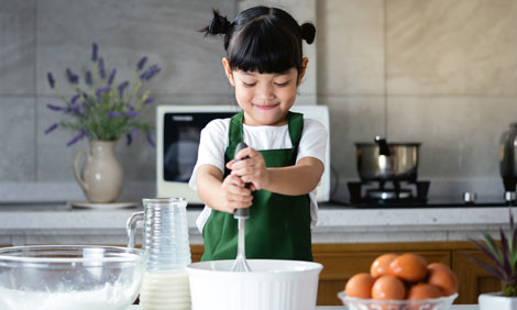 Young girl mixing ingredients in a mixing bowl