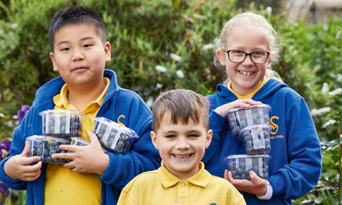 Group of young children holding gifts